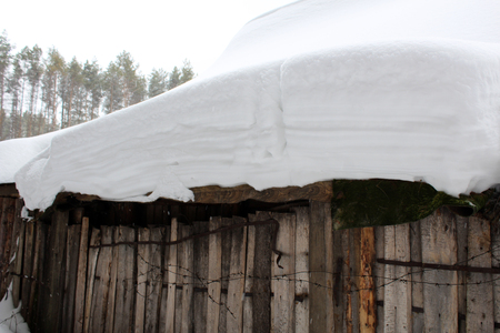 Snowing on a wooden fence, old objectの写真素材