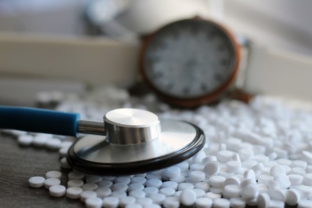 Stethoscope and medication in the form of tablets, macroの写真素材