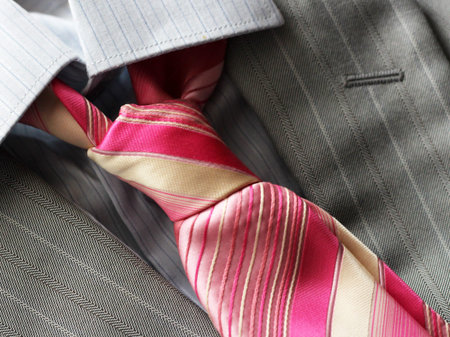 Pink tie and grey men's jacket so closeの写真素材