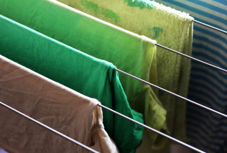 Different types of clothes left hanging to dry so close