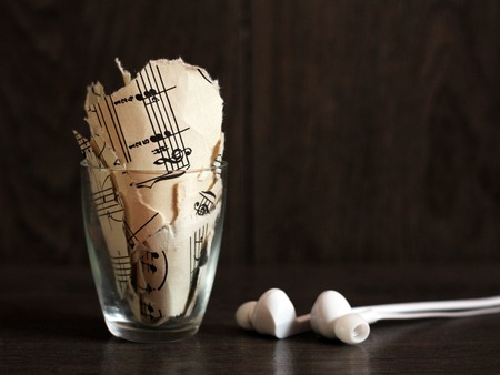 Ragged notes in the glass and headphonesの写真素材