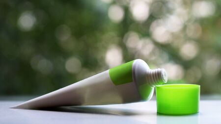 Tube of women's face cream on the background of natureの写真素材