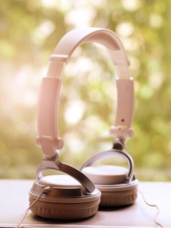 White elegance headfones on nature background, sunlight tonedの写真素材