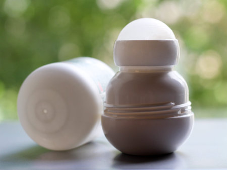 White bottle with Body antiperspirant deodorant roll-on nature background.