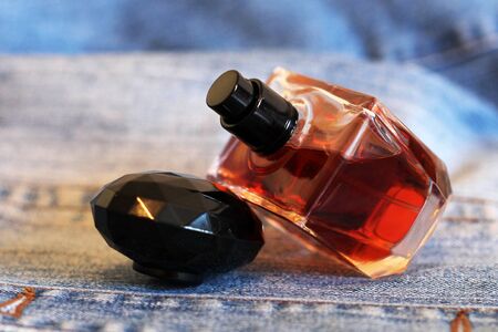 Bottle of perfume on the jeansの写真素材