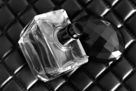 Perfume in glass on leather bag, black and whiteの写真素材