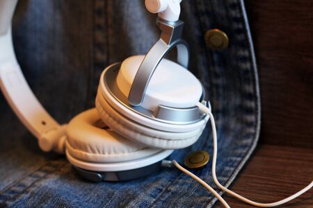 White big headphones and denim jacket so closeの写真素材
