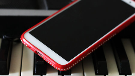 Red smartphone with rhinestones so close