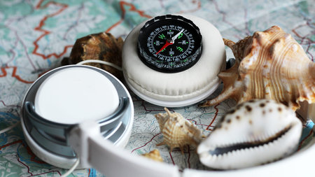 Compass, seashells and a map. A set of traveler's items.