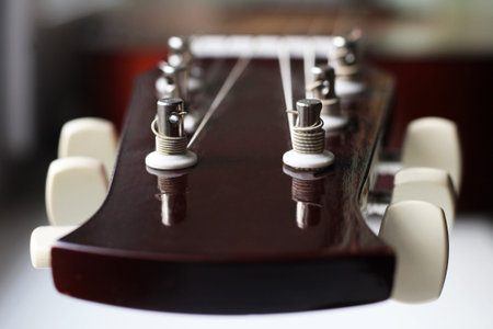 closeup shot of guitar and strings with shallow depth of field