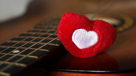 Valentines Day background with hearts on vintage guitarの写真素材