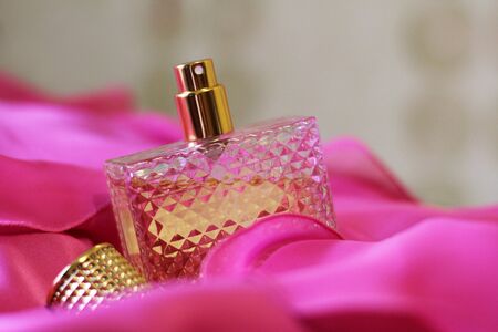 Glass bottles on pink dress so closeの写真素材