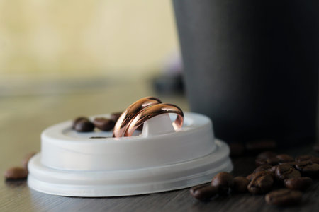 set of wedding rings on coffee beans so close