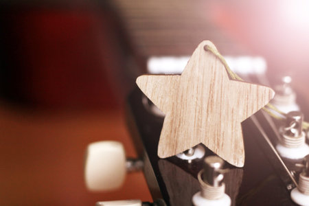 Wooden star and guitar so close, music