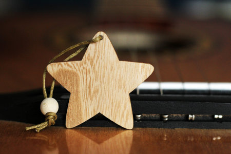Wooden star and guitar so close, music