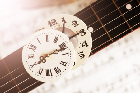 Clock with Roman numerals and guitar, retro composition so close