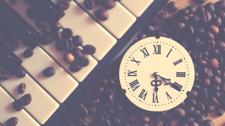 A clock with Roman numerals and a piano, retroの写真素材
