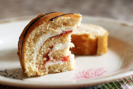 A roll cake with cream and cherries. Summer dessert with berries, food.