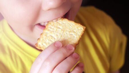 The boy is eating cookies, the portrait is very close, foodの写真素材