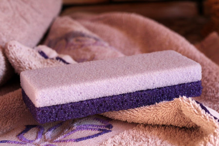 Purple pumice stone for women and pink towel so close