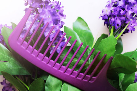 Purple women's hairbrush and flowers so closeの写真素材