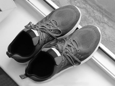 Top view of men's running shoes on a streetの写真素材
