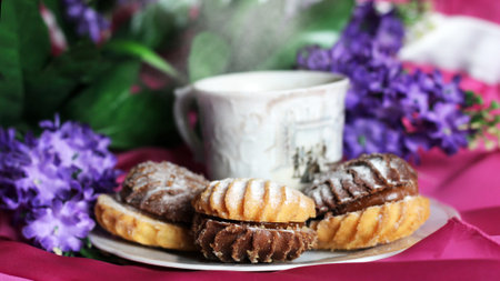 Hot coffee and delicious cookies and flowers so close, Breakfast