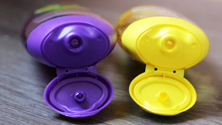 Yellow and purple tube bottle of shampoo, conditioner, hair rinse, gel, soap so close