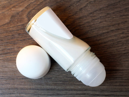 deodorant roll on isolated on wooden background, top view