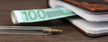 Hundred Euro and business book so closeの写真素材