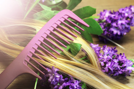Purple comb, blonde hair and flowers.