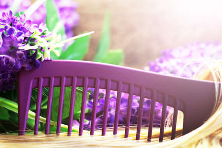 Purple comb, blonde hair and flowers.の写真素材