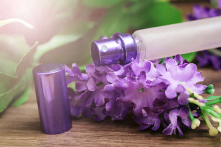 The clear luxury body perfume bottle spray and purple flower so closeの写真素材