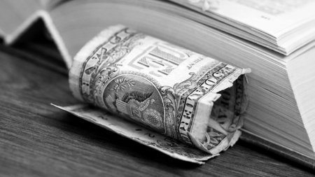 Old books with one dollar. Concept for buyng or selling books.