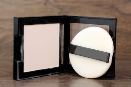 Beige face powder on a wooden background, beautyの写真素材