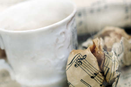 A white cup of coffee with steam and a musical note so closeの写真素材