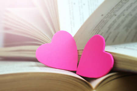 Two pink hearts and books, love and romance imageの写真素材