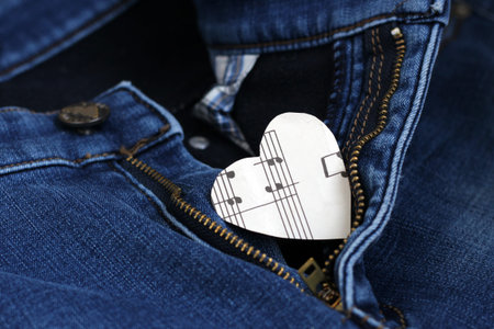 Heart of paper musical notes and jeans so close