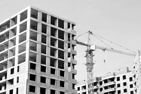 Crane and building construction site against blue sky, outdoor