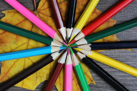 Set of colored pencils folded in a circle, vintage toned