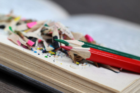 Colored pencils and book, wood chips object