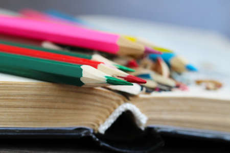 Colored pencils and book, wood chips objectの写真素材