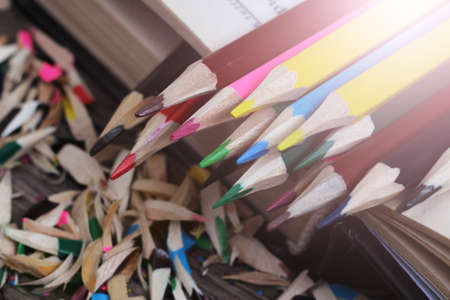 Colored pencils and book, wood chips objectの写真素材