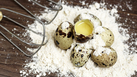 quail eggs in flour on a wooden background, eco food