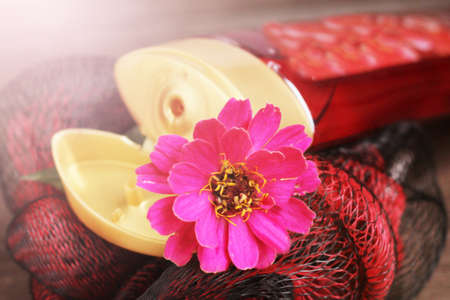 Bottle of perfume and pink flower so closeの写真素材