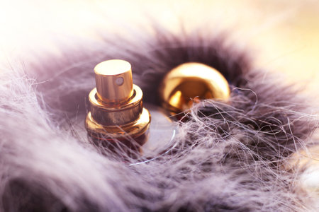 bottle of pink perfume on a fur so close