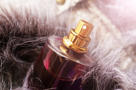 bottle of pink perfume on a fur so close