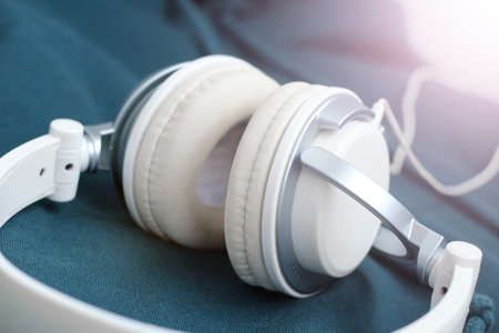 White elegance headfones on blue textile so close