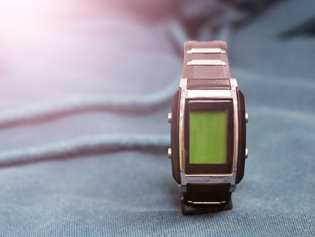 Luxury wristwatch on blue textile background, toned