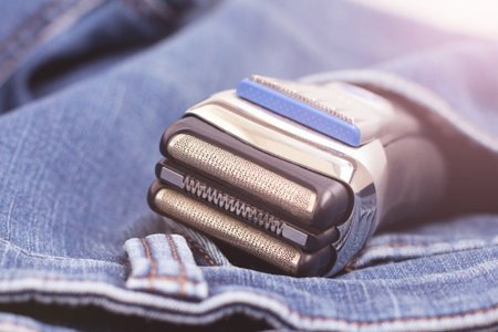Electric shaver on a jeans so closeの写真素材